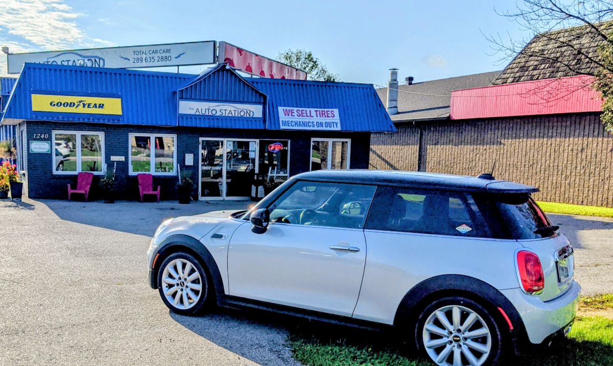 white mini cooper parked at the auto station